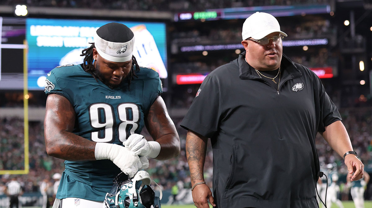 Philadelphia Eagles defensive tackle Jalen Carter (98) walks off the field with Eagles chief security officer Dom DiSandro (R) after being ejected from the game against the Dallas Cowboys at Lincoln Financial Field.