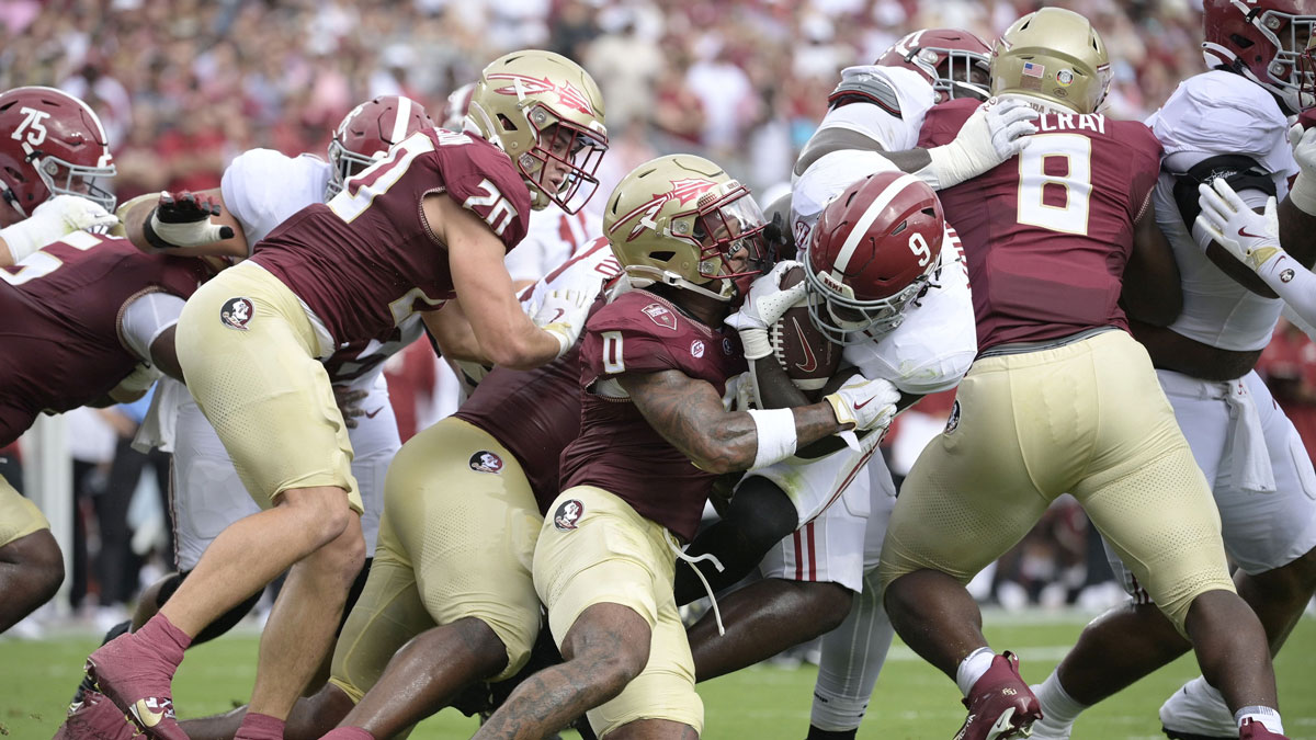 Alabama Crimson Tide running back Richard Young (9) runs with the ball against Florida State Seminoles defensive back Earl Little Jr. (0) during the first half at Doak S. Campbell Stadium.