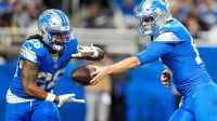 Detroit Lions quarterback Jared Goff (16) hands the ball to unning back Jahmyr Gibbs (26) against Green Bay Packers during the first half at Ford Field in Detroit on Thursday, Dec. 5, 2024.