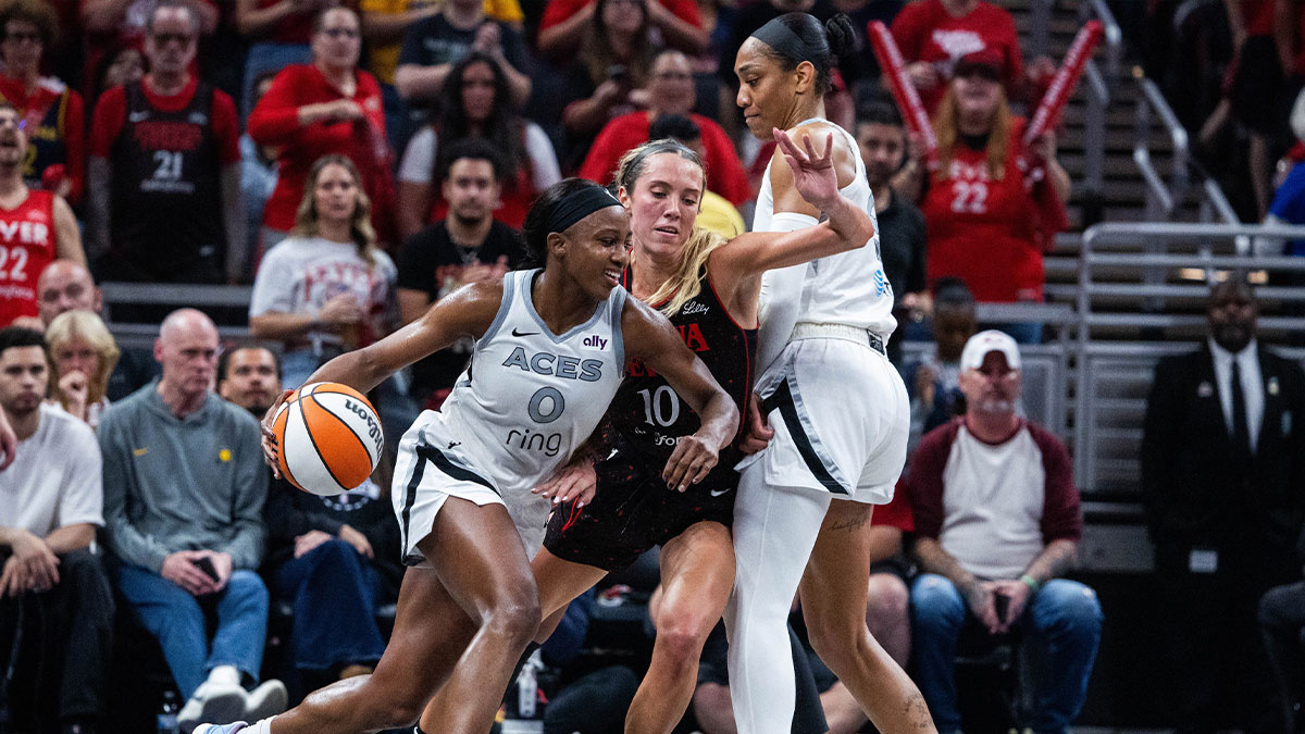 Las Vegas Aces guard Jackie Young (0) dribbles the ball while Indiana Fever guard Lexie Hull (10) defends during game three of the second round for the 2025 WNBA Playoffs at Gainbridge Fieldhouse.