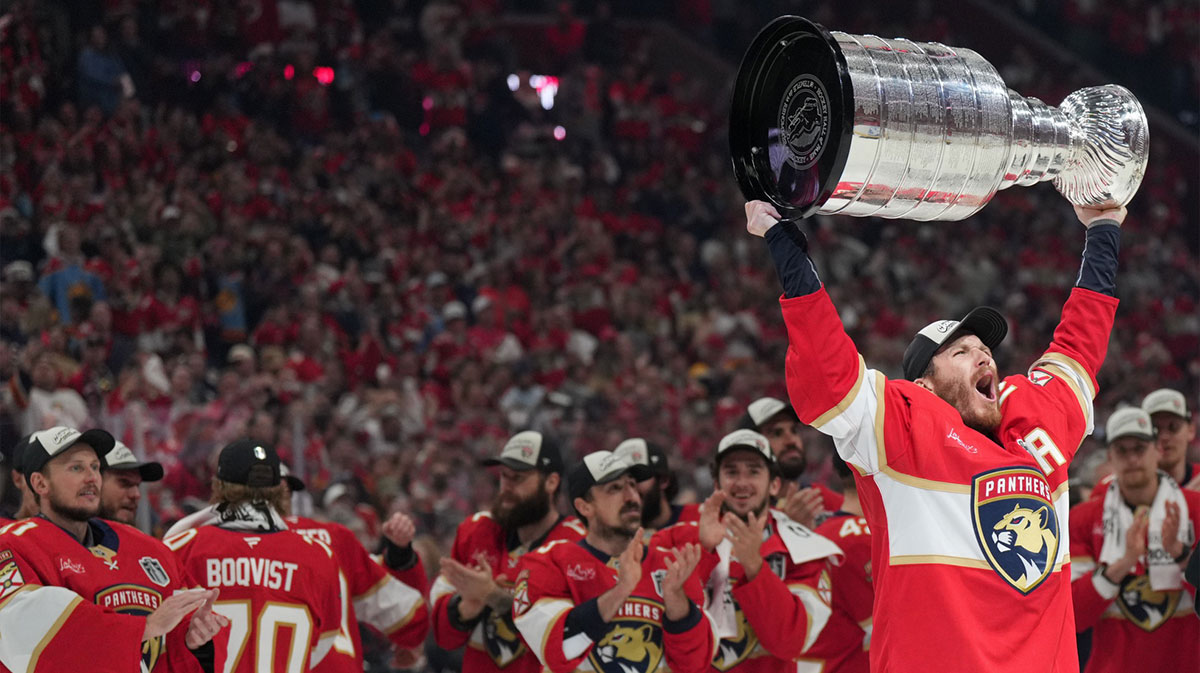 Florida Panthers left wing Matthew Tkachuk (19) hoist the Stanley Cup after game six of the 2025 Stanley Cup Final against the Edmonton Oilers at Amerant Bank Arena.