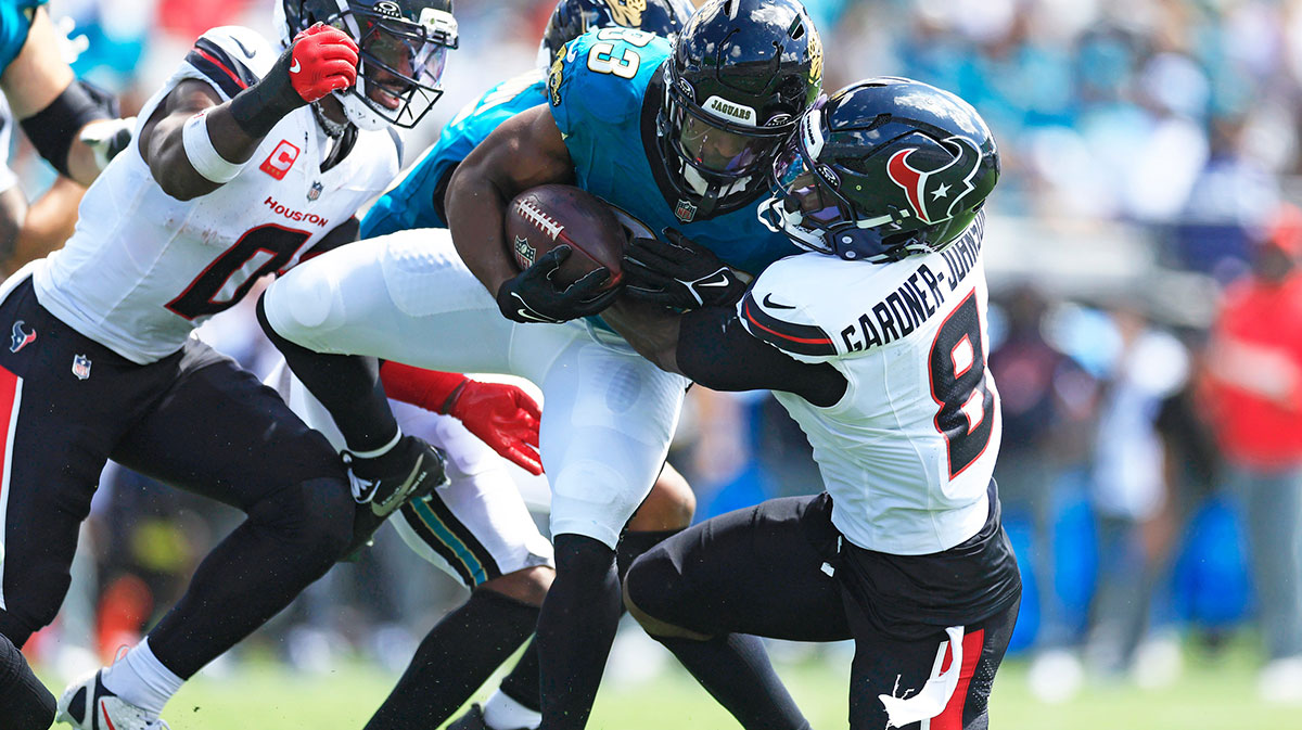 Jacksonville Jaguars running back Bhayshul Tuten (33) is tackled by Houston Texans safety CJ. Gardner-Johnson (8) during the second quarter of an NFL football matchup at EverBank Stadium, Sunday, Sept. 21, 2025, in Jacksonville, Fla. The Jaguars defeated the Texans 17-10