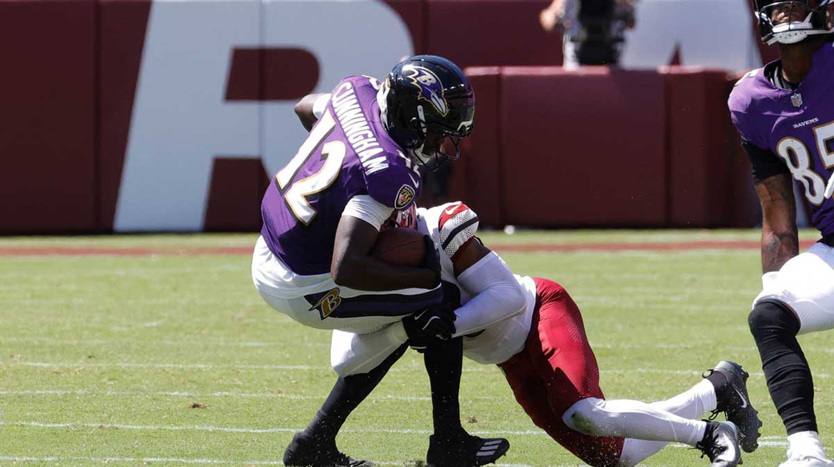 Baltimore Ravens wide receiver Malik Cunningham (12) is tackled by a Washington Commander in the fourth quarter at Northwest Stadium. Mandatory Credit: Jordyn Harris-Imagn Images at Northwest Stadium.