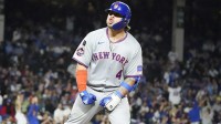 New York Mets catcher Francisco Alvarez (4) gestures to the dugout after hitting a two-run home run against the Chicago Cubs during the eighth inning at Wrigley Field.