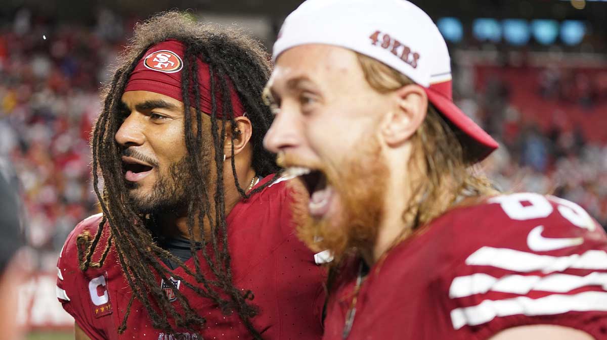 San Francisco 49ers linebacker Fred Warner (54) and tight end George Kittle (85) celebrate after defeating the Green Bay Packers in a 2024 NFC divisional round game at Levi's Stadium.