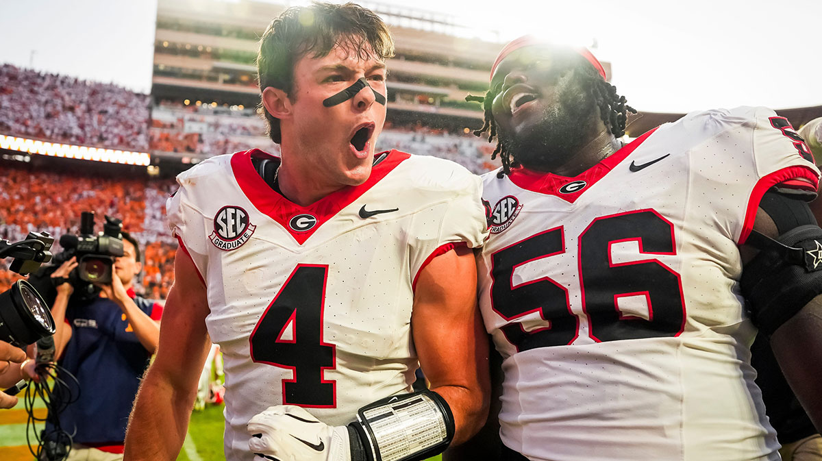 Georgia tight end Oscar Delp (4) and Georgia offensive lineman Micah Morris (56) celebrate their overtime win against Tennessee at Neyland Stadium in Knoxville, Tenn., on Sept. 13, 2025.