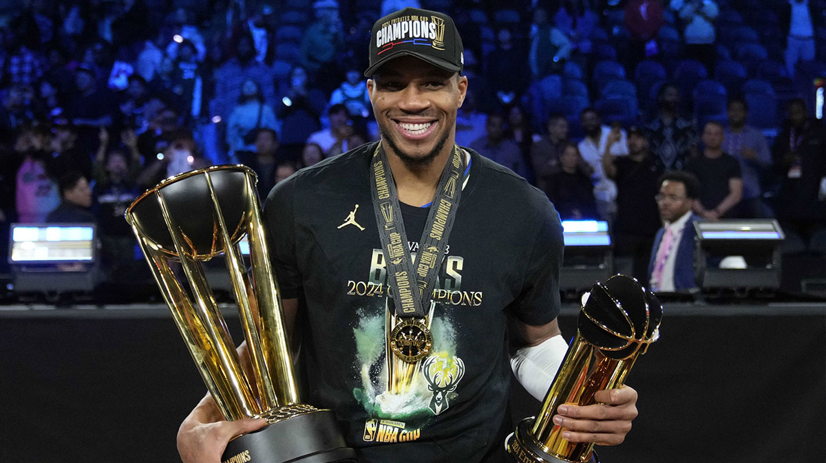 Milwaukee Bucks forward Giannis Antetokounmpo (34) celebrates with the most valuable player and championship trophies after winning the Emirates NBA Cup championship game against the Oklahoma City Thunder at T-Mobile Arena.