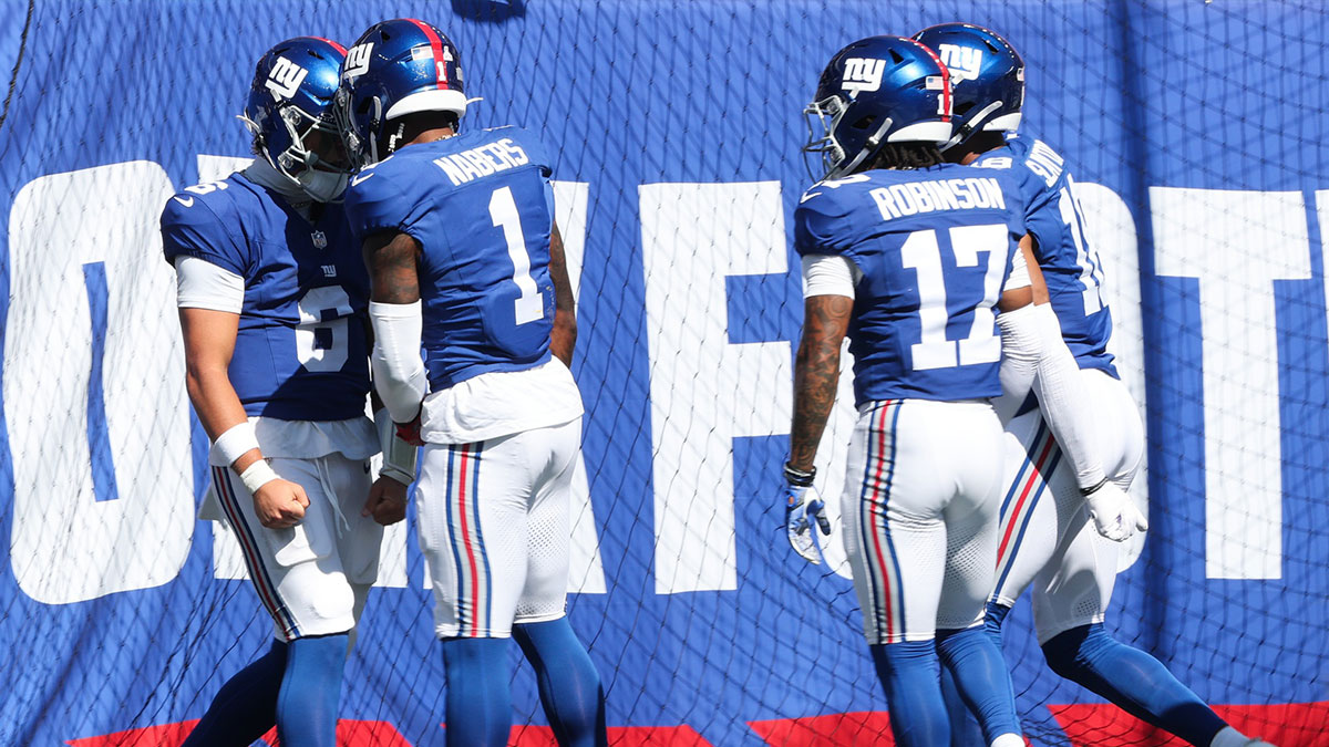 New York Giants quarterback Jaxson Dart (6) celebrates with New York Giants wide receiver Malik Nabers (1) after scoring a touchdown during the first quarter against the Los Angeles Chargers at MetLife Stadium.