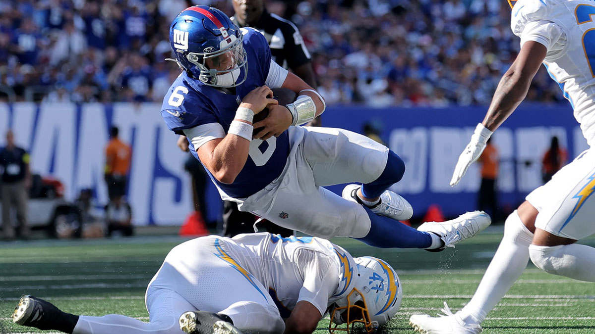 New York Giants quarterback Jaxson Dart (6) is tackled by Los Angeles Chargers linebacker Troy Dye (43) and cornerback Tarheeb Still (29) during the fourth quarter.