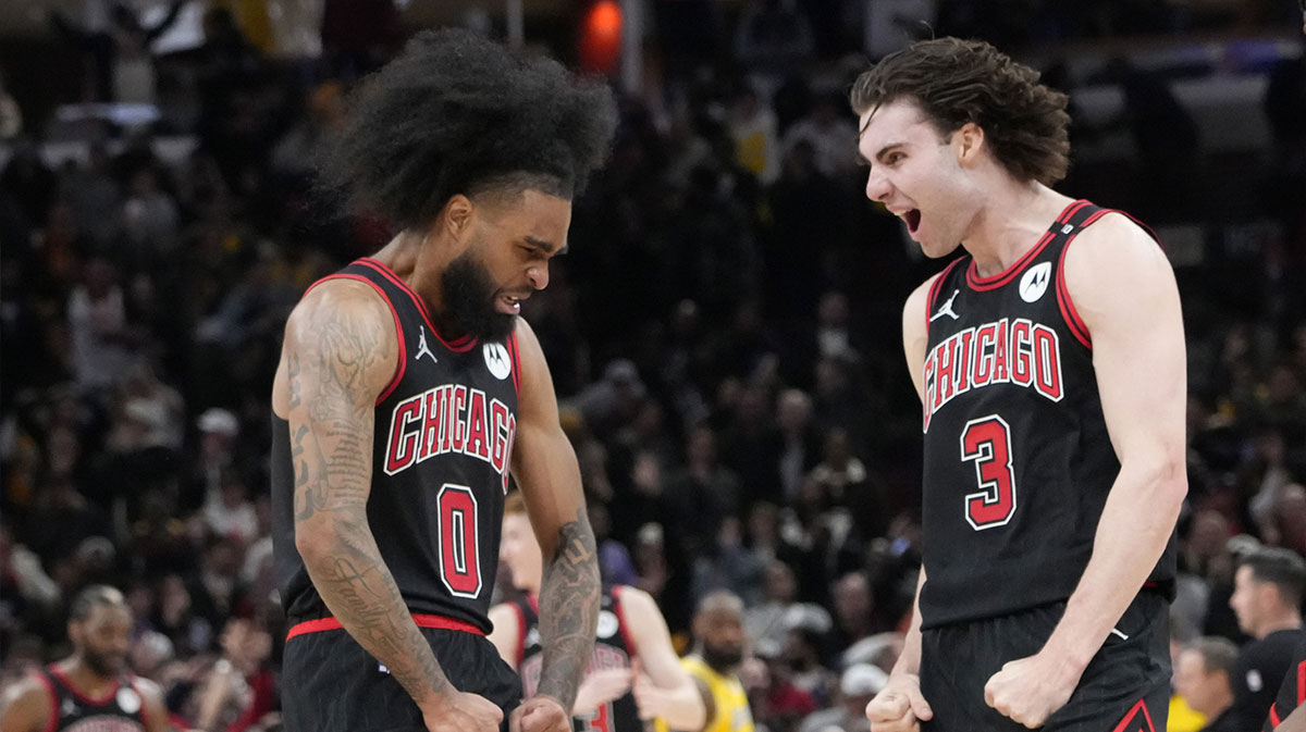 Chicago Bulls guard Coby White (0) celebrates his three point basket against the Los Angeles Lakers with guard Josh Giddey (3) during the second half at United Center.