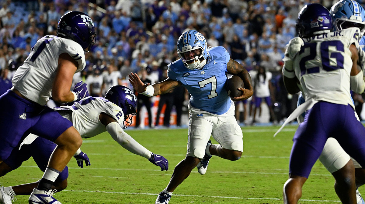 North Carolina Tar Heels quarterback Gio Lopez (7) with the ball as TCU Horned Frogs safety Jamel Johnson (2) defends in the first quarter at Kenan Stadium.