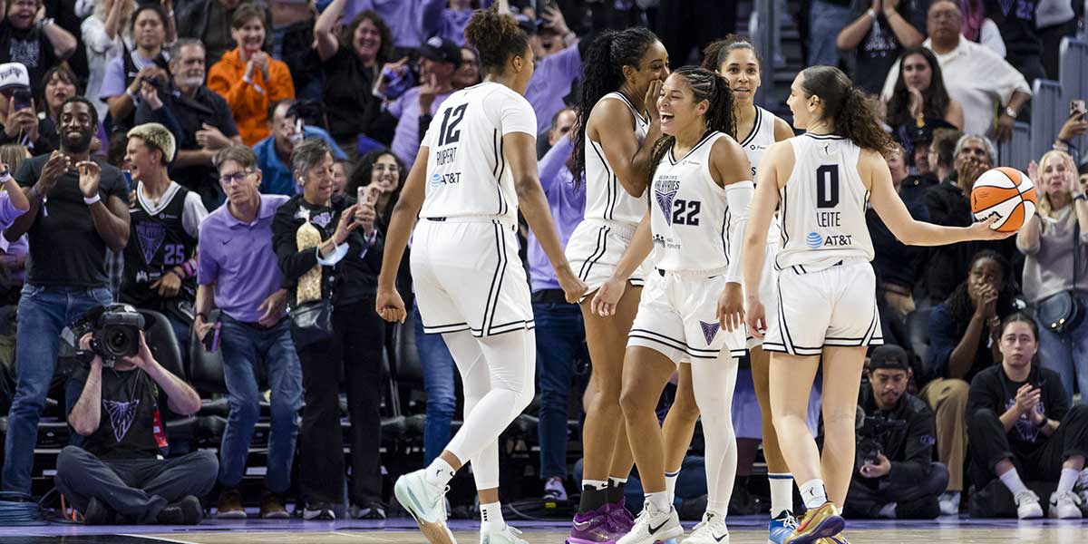 Golden State Valkyries guard Veronica Burton (22) is congratulated by center Iliana Rupert (12) and guard Carla Leite (0) after she scored against the Dallas Wings during the second half at Chase Center.