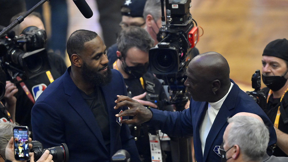 Lebron James and Michael Jordan on court during halftime during the 2022 NBA All-Star Game at Rocket Mortgage FieldHouse with Lakers' Magic Johnson in the background