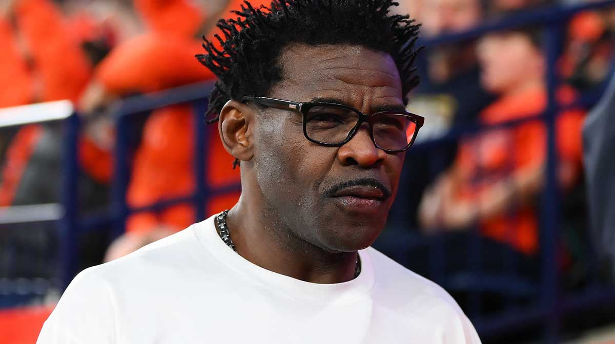 Michael Irvin looks on during the first half of a game between the Miami Hurricanes and the Syracuse Orange at the JMA Wireless Dome
