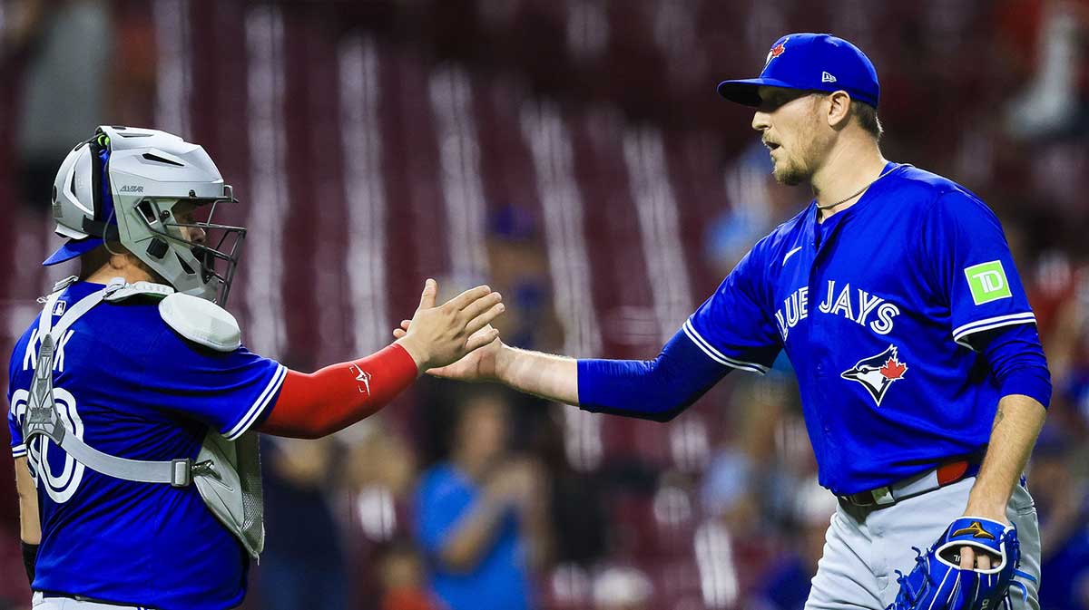 Toronto Blue Jays catcher Alejandro Kirk (30) shakes hands with relief pitcher Jeff Hoffman (23) after the victory over the Cincinnati Reds at Great American Ball Park.