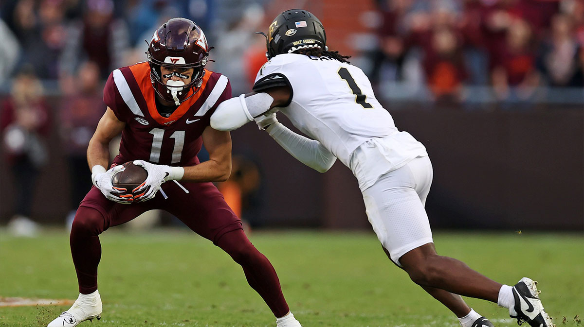 Virginia Tech Hokies wide receiver Tucker Holloway (11) catches a pass against Wake Forest Demon Deacons defensive back Caelen Carson (1) during the fourth quarter at Lane Stadium.