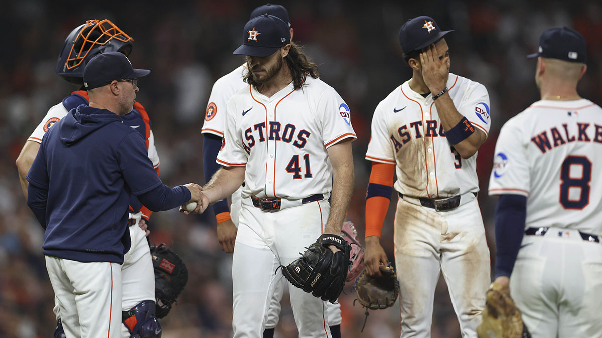 Houston Astros starting pitcher Spencer Arrighetti (41) hands the ball ot manager Joe Espada (19) during a pitching change in the seventh inning against the Los Angeles Angels at Daikin Park.