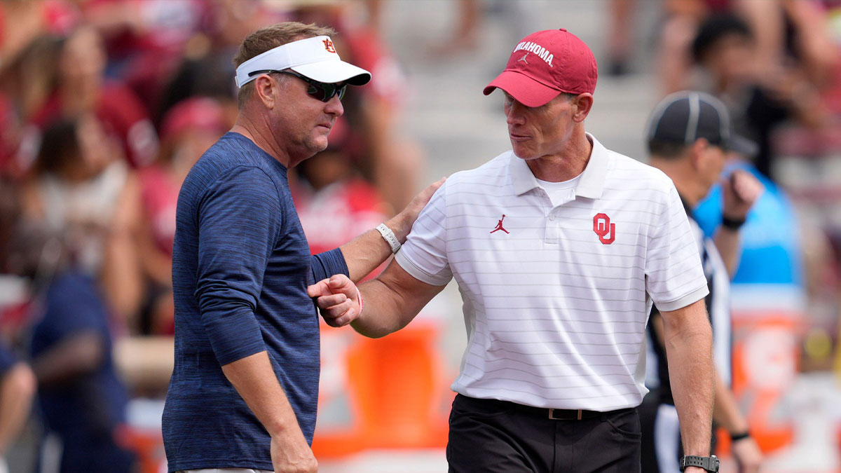 Oklahoma coach Brent Venables and Auburn coach Hugh Freeze talk before a college football game between the University of Oklahoma Sooners (OU) and the Auburn Tigers at Gaylord Family Ð Oklahoma Memorial Stadium in Norman, Okla., Saturday, Sept. 20, 2025.