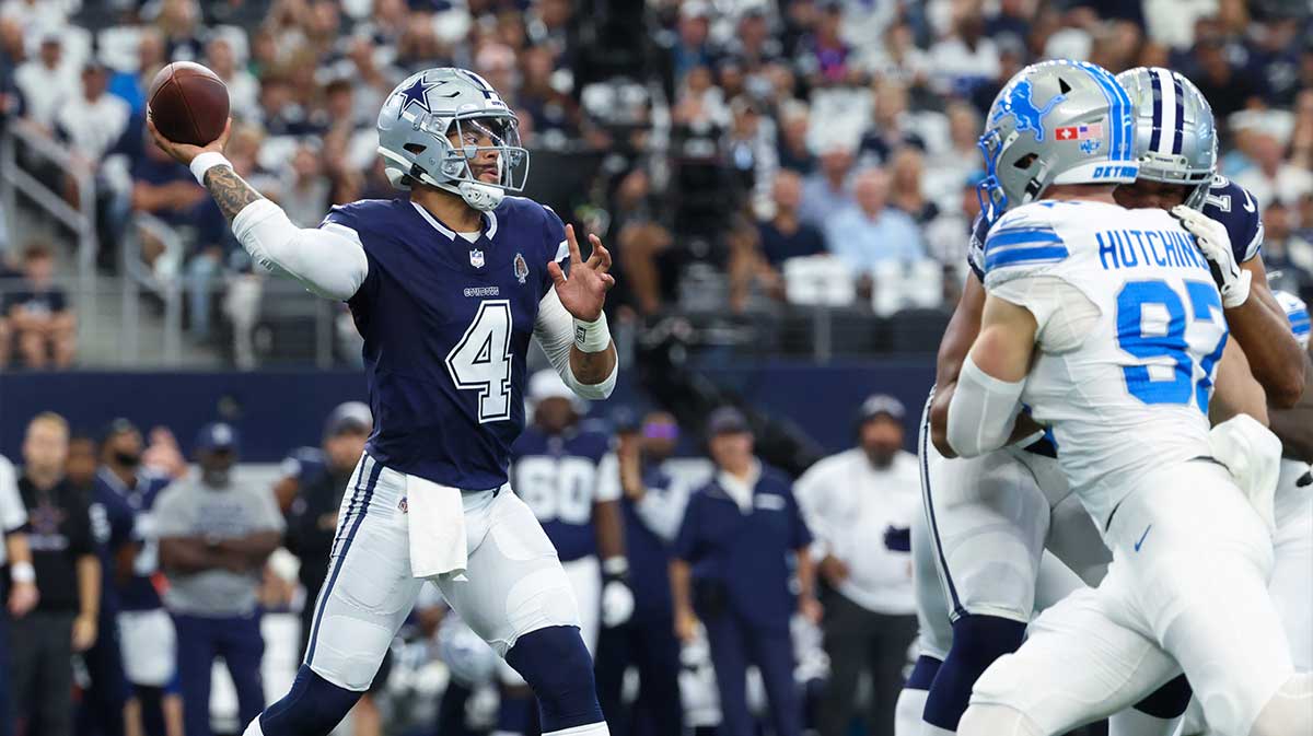 Dallas Cowboys quarterback Dak Prescott (4) throws as Detroit Lions defensive end Aidan Hutchinson (97) rushes during the first quarter at AT&T Stadium.