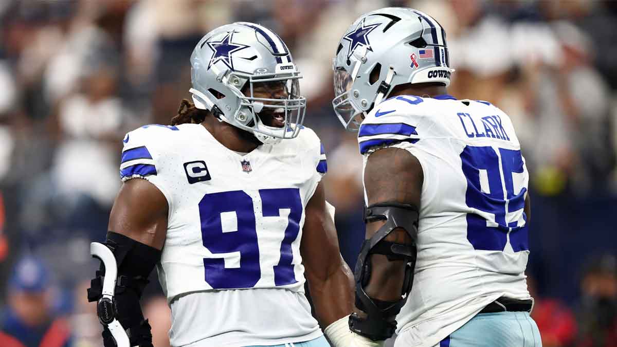 Dallas Cowboys defensive tackle Osa Odighizuwa (97) celebrates with defensive tackle Kenny Clark (95) after a play against the New York Giants during the second quarter at AT&T Stadium. 