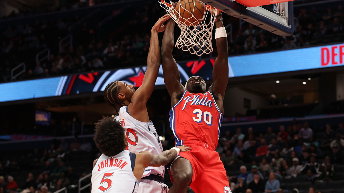 Philadelphia 76ers center Adem Bona (30) dunks the ball as Washington Wizards forward Alex Sarr (20) defends in the first half at Capital One Arena.