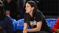 Indiana Fever guard Caitlin Clark (22) looks on from the bench against the Washington Mystics during the first quarter at CFG Bank Arena.