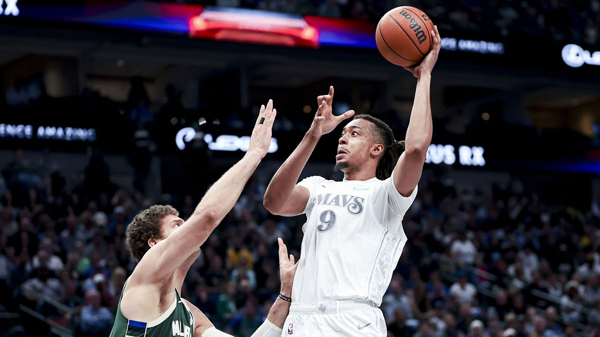 ; Dallas Mavericks center Moses Brown (9) shoots over Milwaukee Bucks center Brook Lopez (11) during the first half at American Airlines Center.