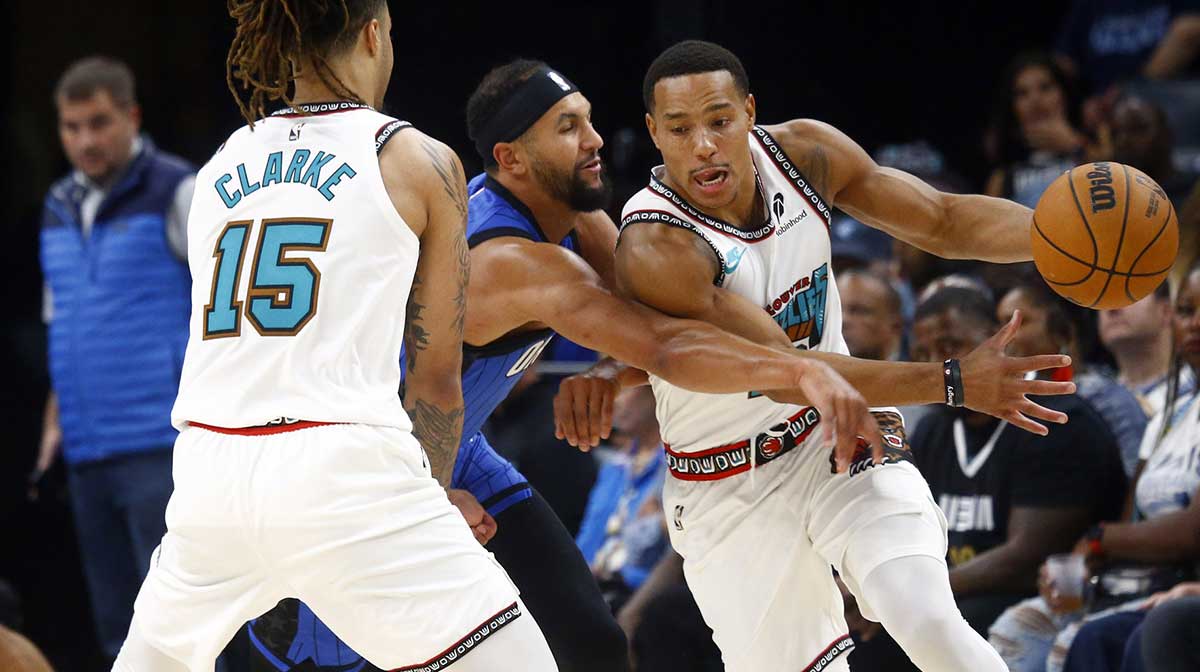 Memphis Grizzlies guard Desmond Bane (22) dribbles around a screen set by forward Brandon Clarke (15) on Orlando Magic guard Jalen Suggs (4) during the first half at FedExForum.