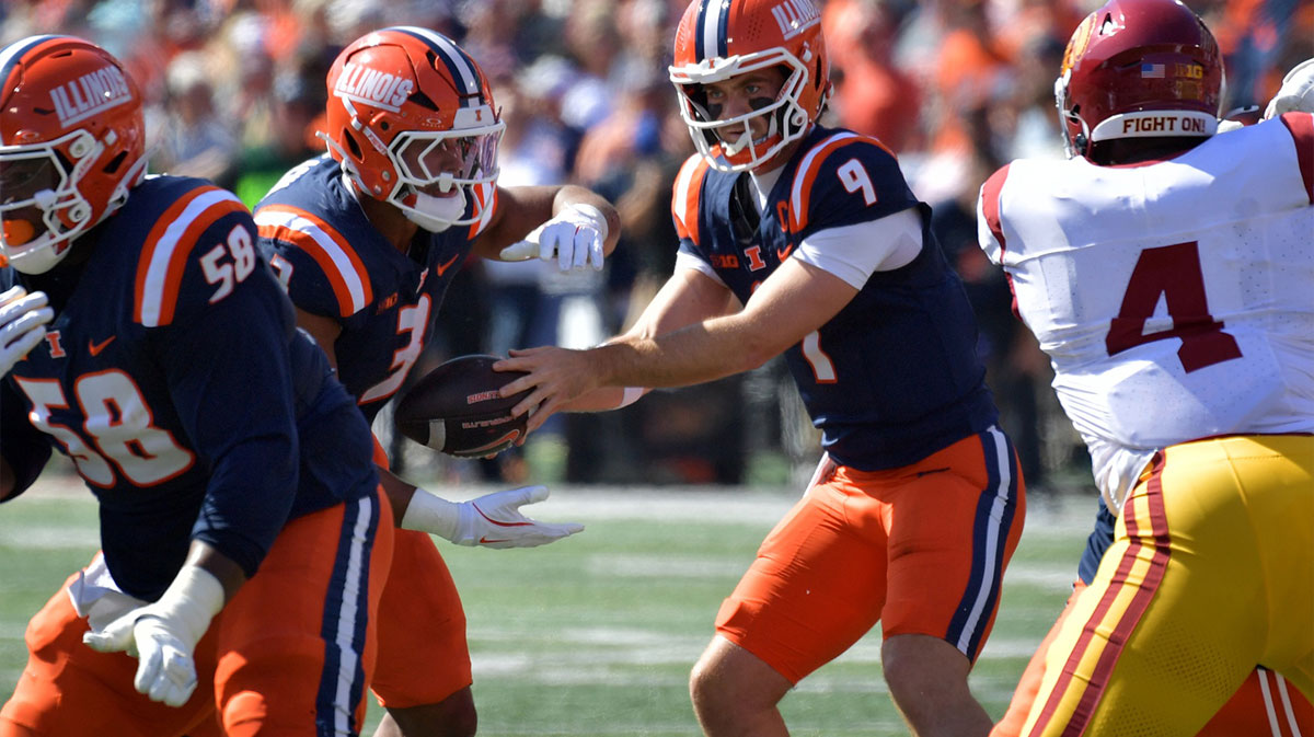 Illinois Fighting Illini quarterback Luke Altmyer (9) hands the ball to running back Kaden Feagin (3) during the first half at Memorial Stadium.