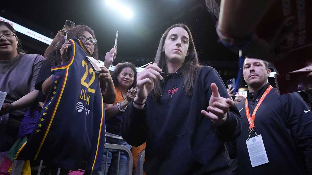 Indiana Fever guard Caitlin Clark signs autographs before a game against the Phoenix Mercury at PHX Arena on Sept. 2, 2025.