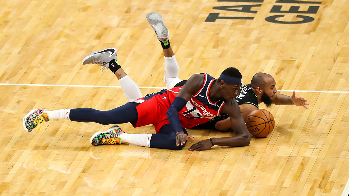 Washington Wizards forward Isaac Bonga (17) and Minnesota Timberwolves guard Jordan McLaughlin (behind) battle for a loose ball in the fourth quarter at Target Center.