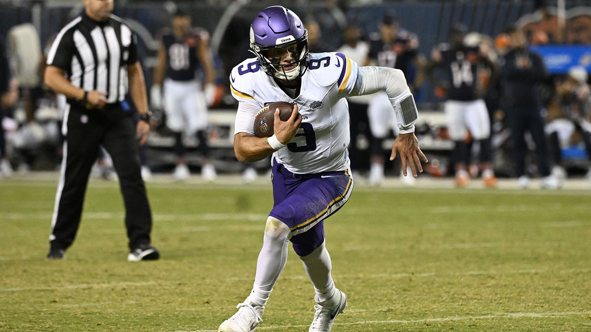 Minnesota Vikings quarterback J.J. McCarthy (9) rushes the ball against the Chicago Bears during the second half at Soldier Field.