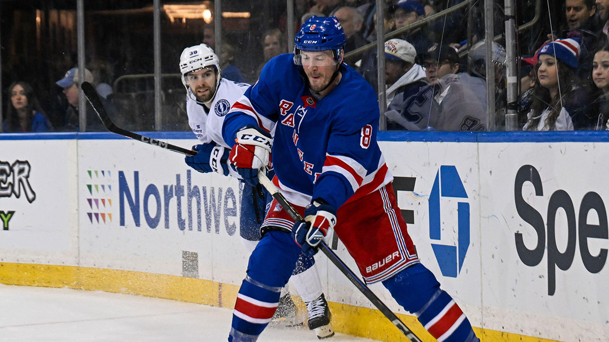 New York Rangers left wing J.T. Miller (8) plays the puck from behind the net against the Tampa Bay Lightning