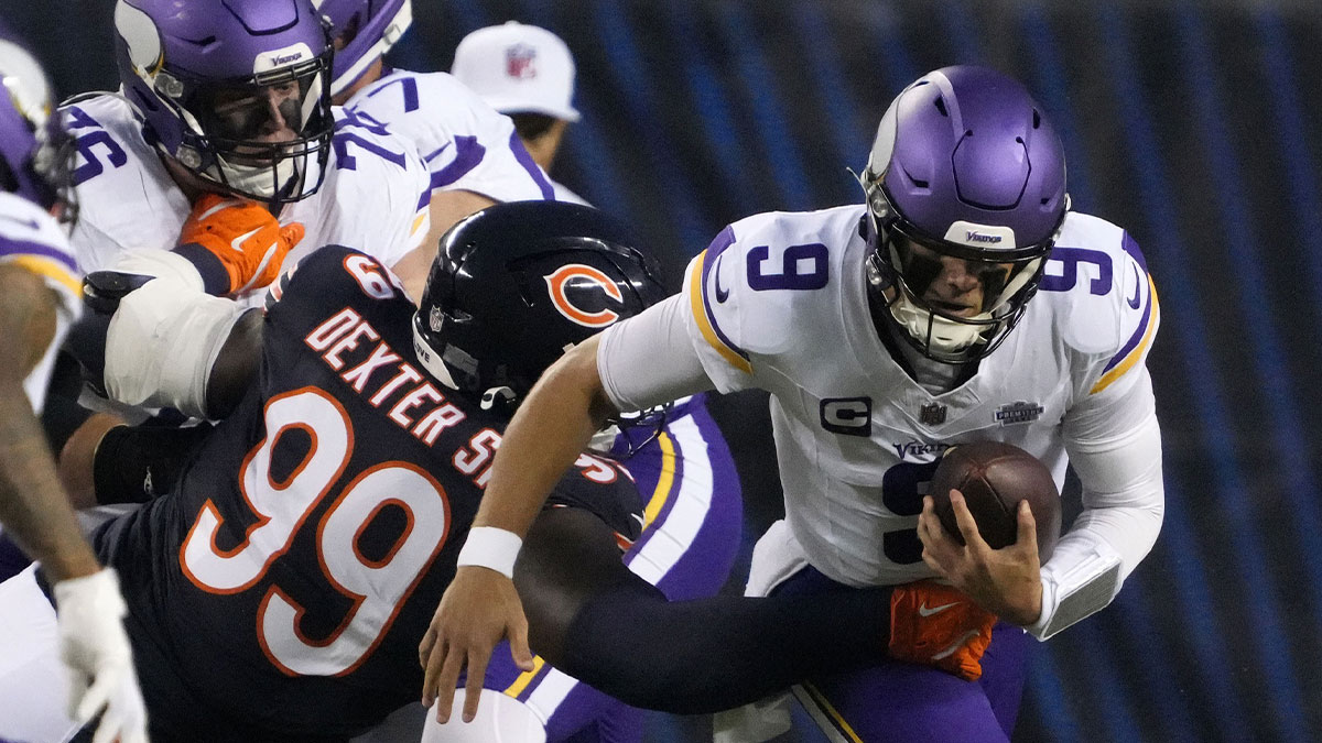 Chicago Bears defensive tackle Gervon Dexter Sr. (99) tackles Minnesota Vikings quarterback J.J. McCarthy (9) during the first half at Soldier Field.