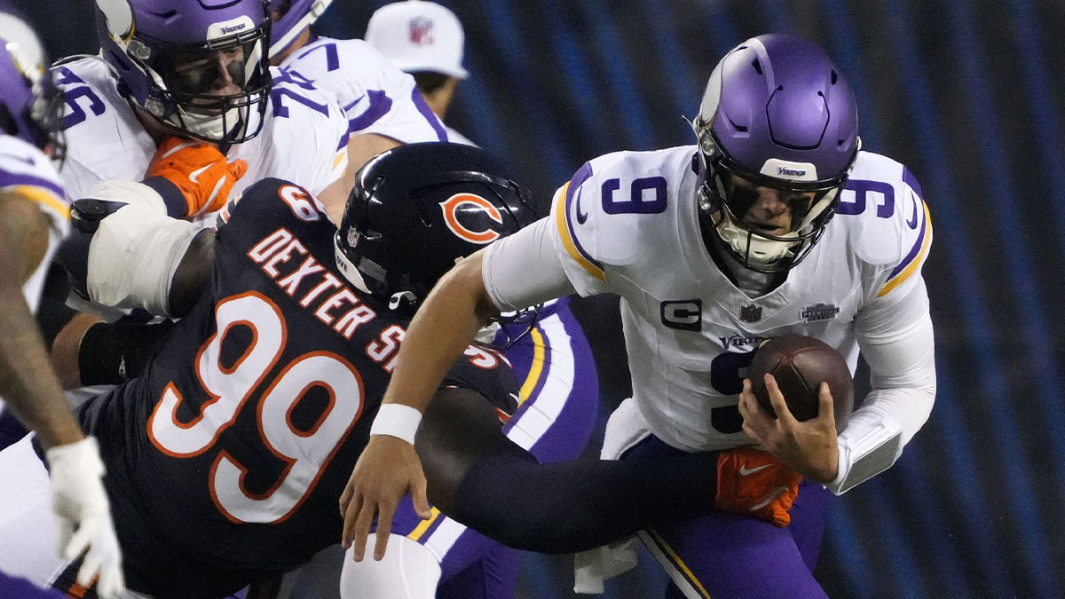 Chicago Bears defensive tackle Gervon Dexter Sr. (99) tackles Minnesota Vikings quarterback J.J. McCarthy (9) during the first half at Soldier Field.