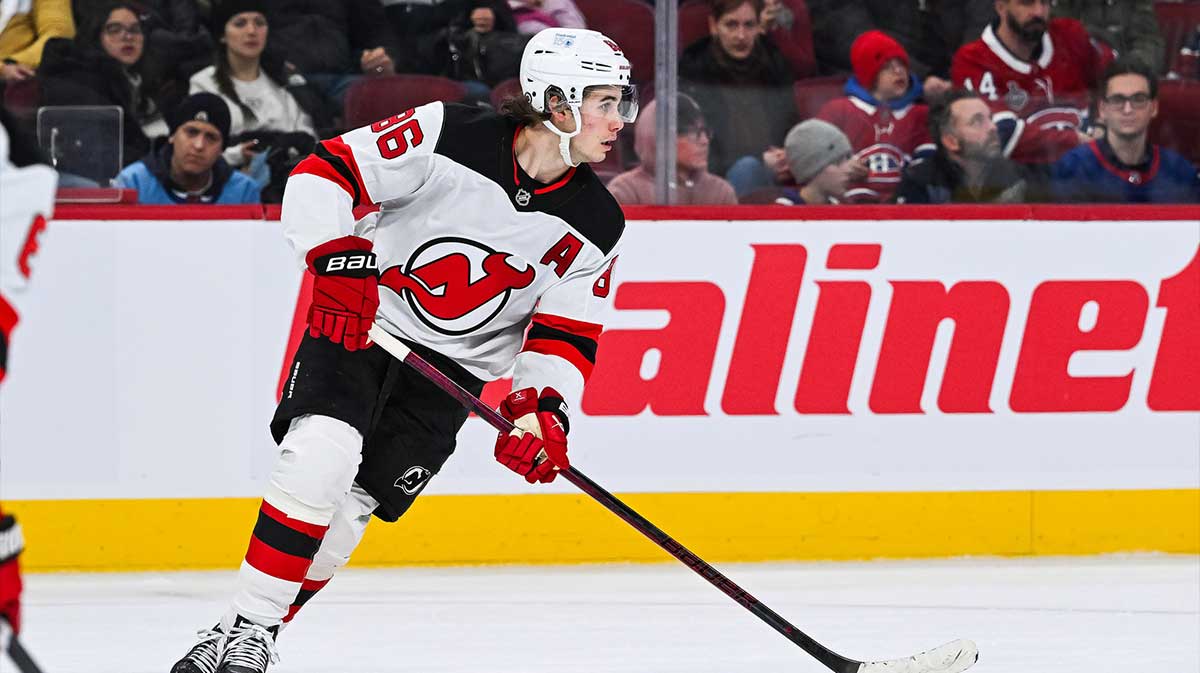 New Jersey Devils center Jack Hughes (86) plays the puck against the Montreal Canadiens during the second period at Bell Centre