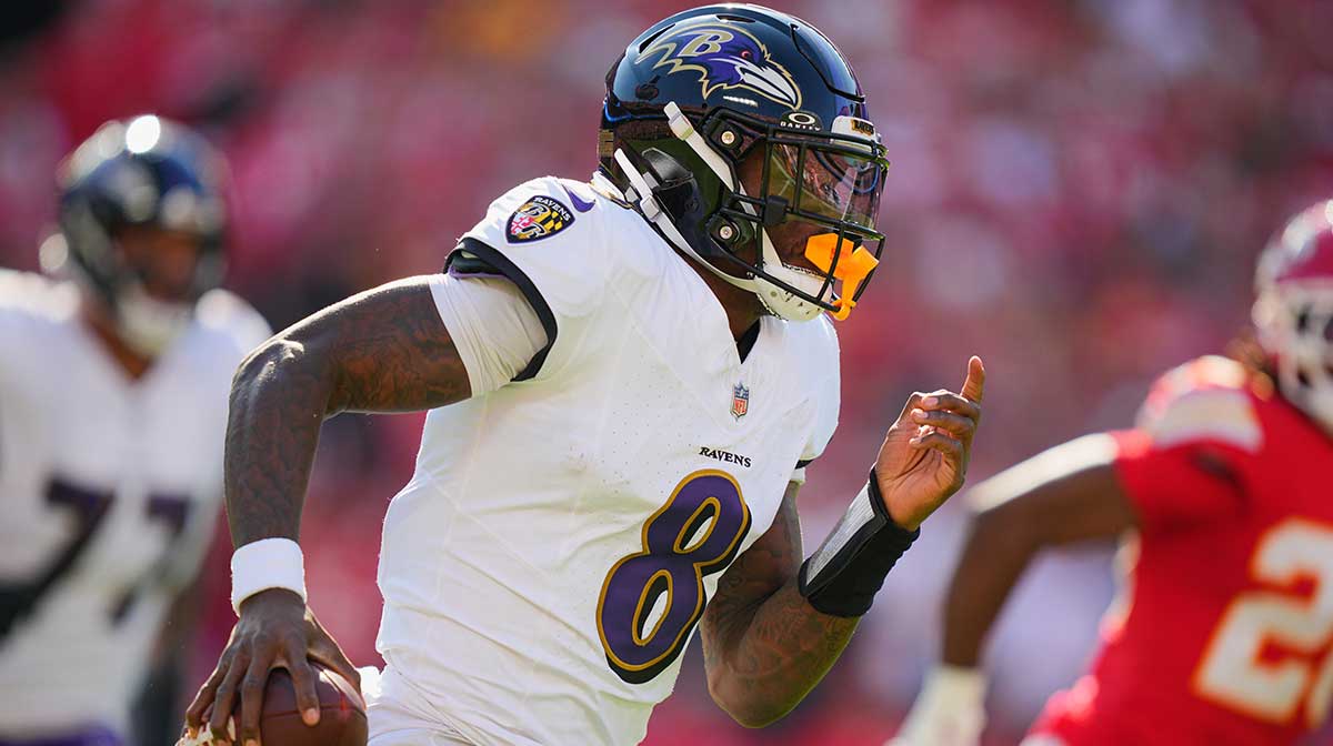 Baltimore Ravens quarterback Lamar Jackson (8) scrambles during the first half against the Kansas City Chiefs at GEHA Field at Arrowhead Stadium.