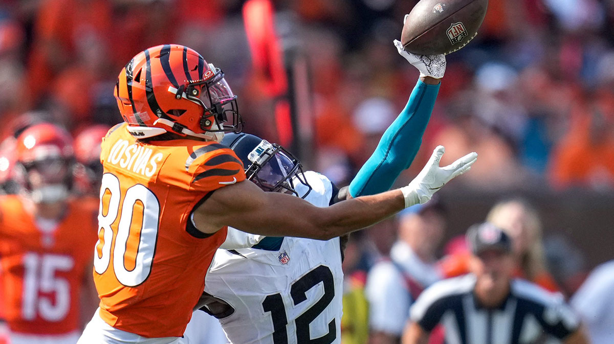 Jacksonville Jaguars defensive back Travis Hunter (12) breaks up a pass intended for Cincinnati Bengals wide receiver Andrei Iosivas (80) before a pass interference penalty is called in the fourth quarter of the NFL Week 2 game between the Cincinnati Bengals and the Jacksonville Jaguars at Paycor Stadium in downtown Cincinnati on Sunday, Sept. 14, 2025. The Bengals came back from a halftime deficit to win 31-27.