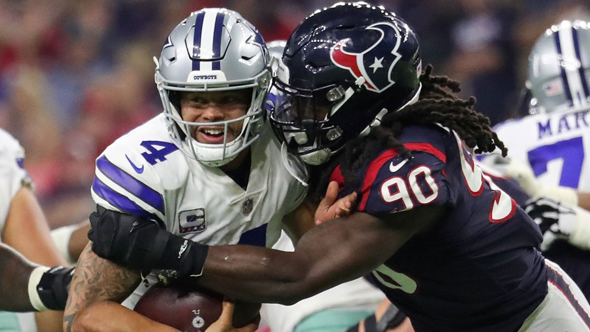 Dallas Cowboys quarterback Dak Prescott (4) evades the tackle of Houston Texans linebacker Jadeveon Clowney (90) during the second half at NRG Stadium.