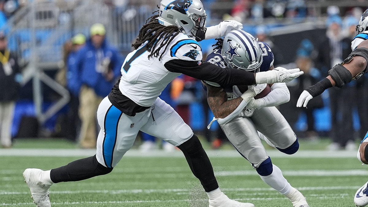 Dallas Cowboys wide receiver Jalen Brooks (83) is tackled by Carolina Panthers linebacker Jadeveon Clowney (7) during the second half at Bank of America Stadium.