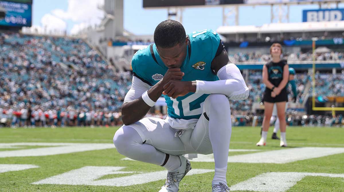 Jacksonville Jaguars wide receiver Travis Hunter (12) crouches in the end zone after taking the field prior to a game against the Carolina Panthers at EverBank Stadium.