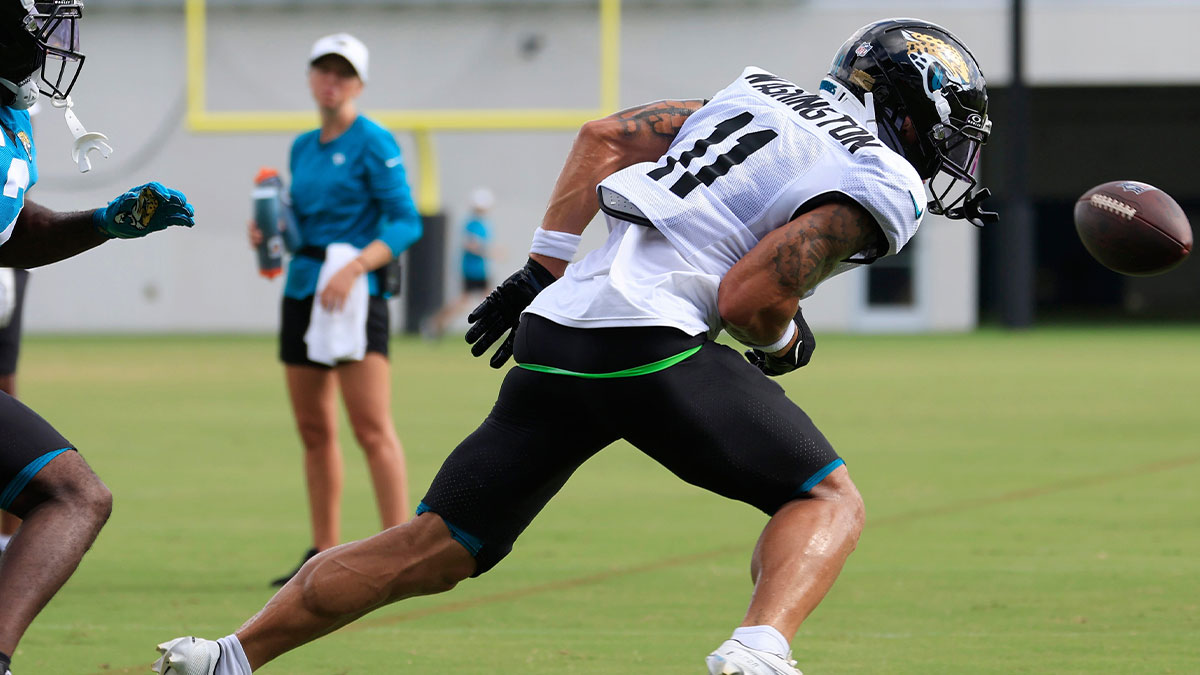 Jaguars quarterback Trevor Lawrence (16), not shown, sails out of reach for wide receiver Parker Washington (11) as cornerback Jourdan Lewis (2) defends during an NFL training camp session at the Miller Electric Center