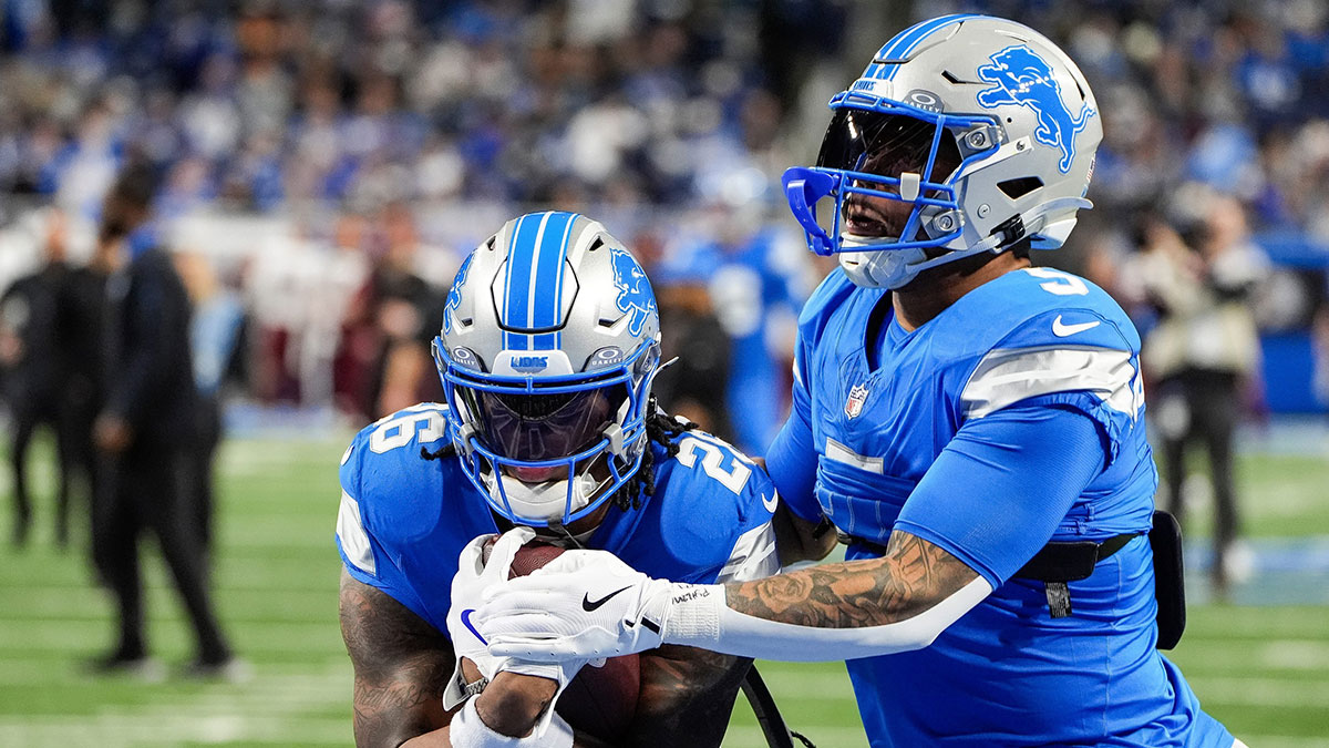 Detroit Lions running back Jahmyr Gibbs (26) warms up with running back David Montgomery (5) before the NFC divisional round at Ford Field in Detroit on Saturday, Jan. 18, 2025.