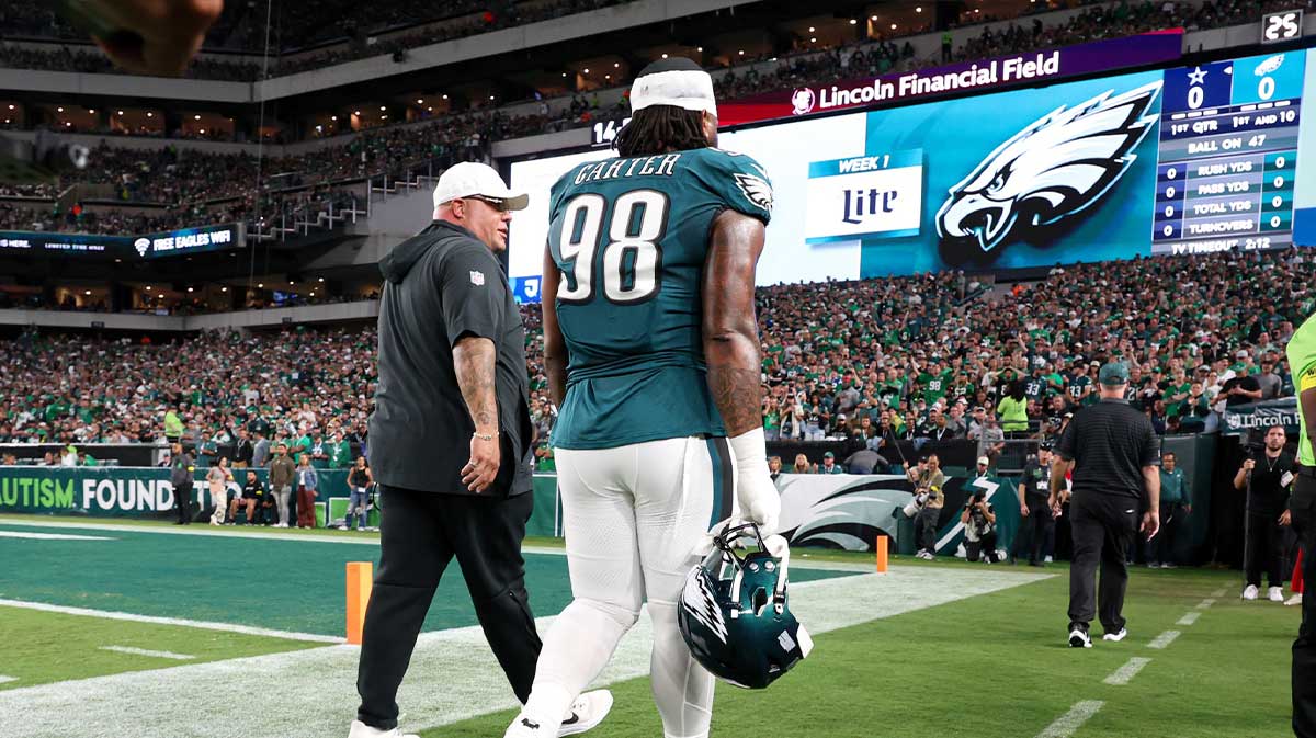 Philadelphia Eagles defensive tackle Jalen Carter (98) walks off the field with Eagles chief security officer Dom DiSandro (L) after being ejected from the game against the Dallas Cowboys at Lincoln Financial Field.
