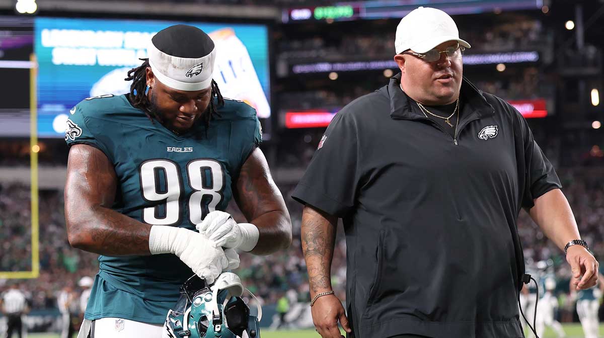 Philadelphia Eagles defensive tackle Jalen Carter (98) walks off the field with Eagles chief security officer Dom DiSandro (R) after being ejected from the game against the Dallas Cowboys at Lincoln Financial Field.
