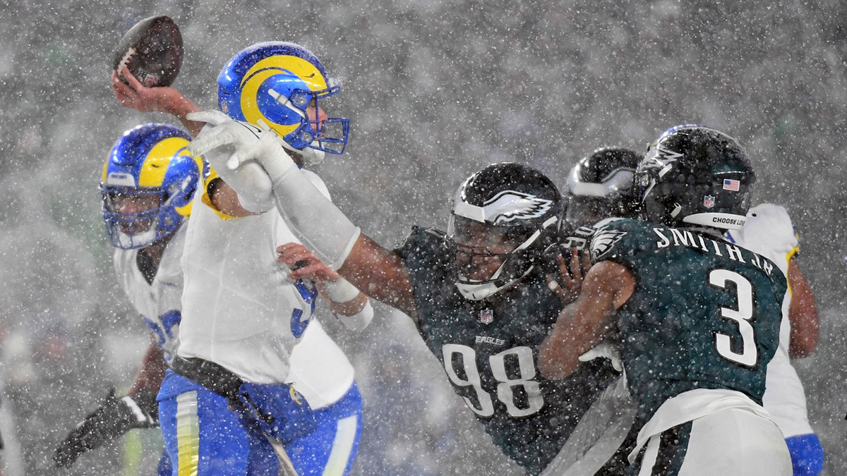 Los Angeles Rams quarterback Matthew Stafford (9) is pressured by Philadelphia Eagles defensive tackle Jalen Carter (98) during the fourth quarter in a 2025 NFC divisional round game at Lincoln Financial Field.