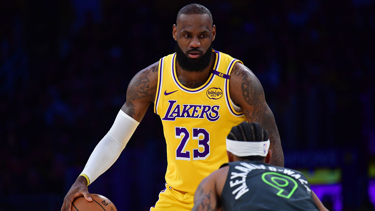 Los Angeles Lakers forward LeBron James (23) controls the ball against Minnesota Timberwolves guard Nickeil Alexander-Walker (9) during the first half in game five of first round for the 2025 NBA Playoffs at Crypto.com Arena.