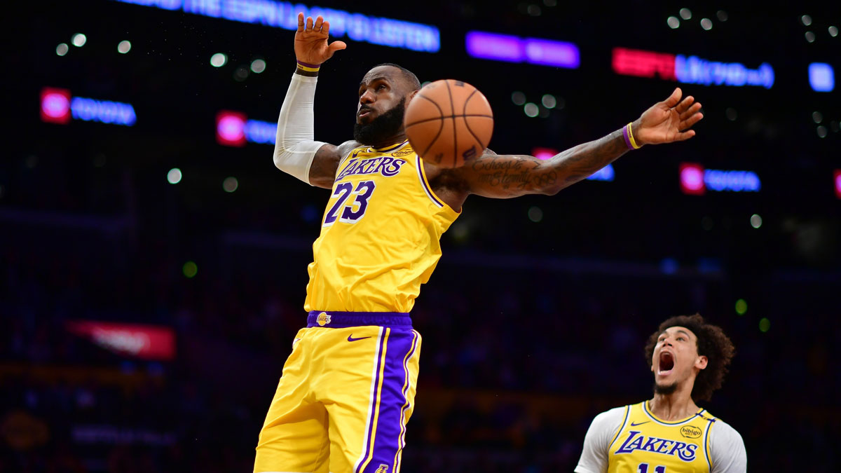 Los Angeles Lakers forward LeBron James (23) scores a basket against the Miami Heat as center Jaxson Hayes (11) reacts during the second half at Crypto.com Arena.