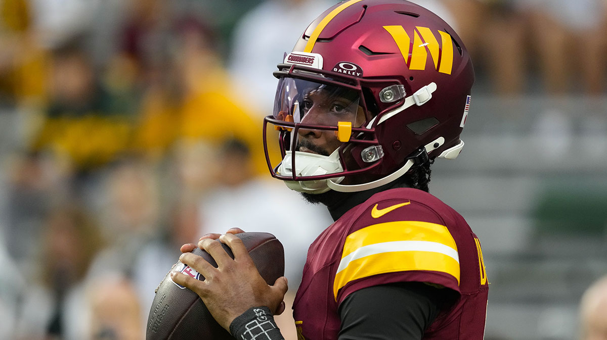 Washington Commanders quarterback Jayden Daniels (5) during warmups prior to the game against the Green Bay Packers at Lambeau Field.