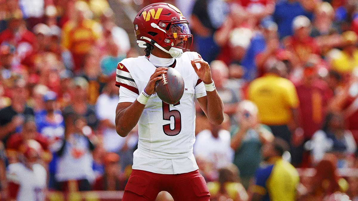Washington Commanders quarterback Jayden Daniels (5) makes a pass during the fourth quarter against the New York Giants at Northwest Stadium.